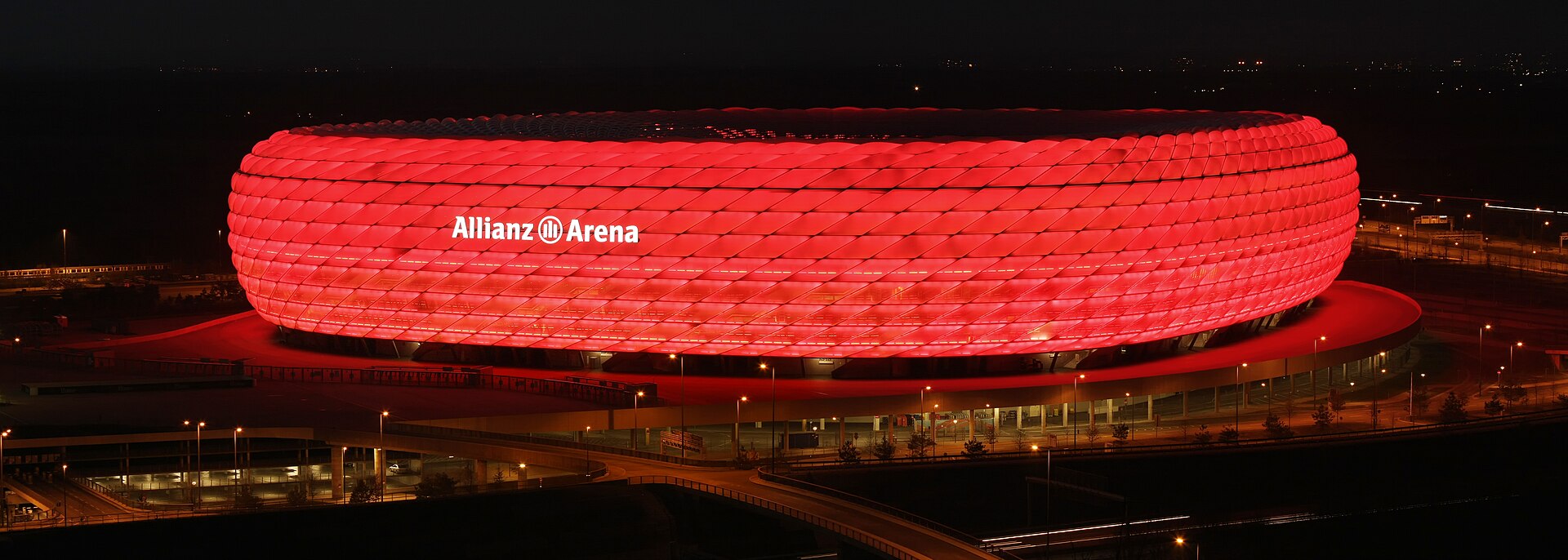 Allianz Arena stadium at night in Munich, Germany, illuminated in red lights, home of FC Bayern Munich