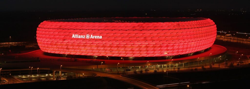 Allianz Arena stadium at night illuminated in red in Munich