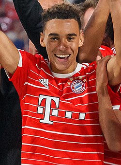 Jamal Musiala celebrating with Bayern Munich after winning the 2022 DFL Supercup