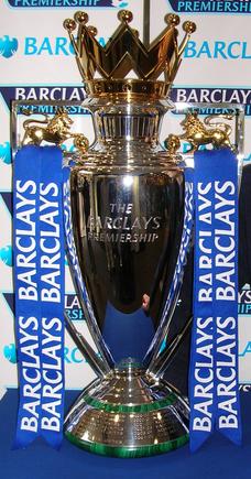 Man United vs Liverpool Preview: All You Need To Know About the Big Match Premier League trophy displayed with its iconic golden crown design and silver body, symbolizing the championship title in English football